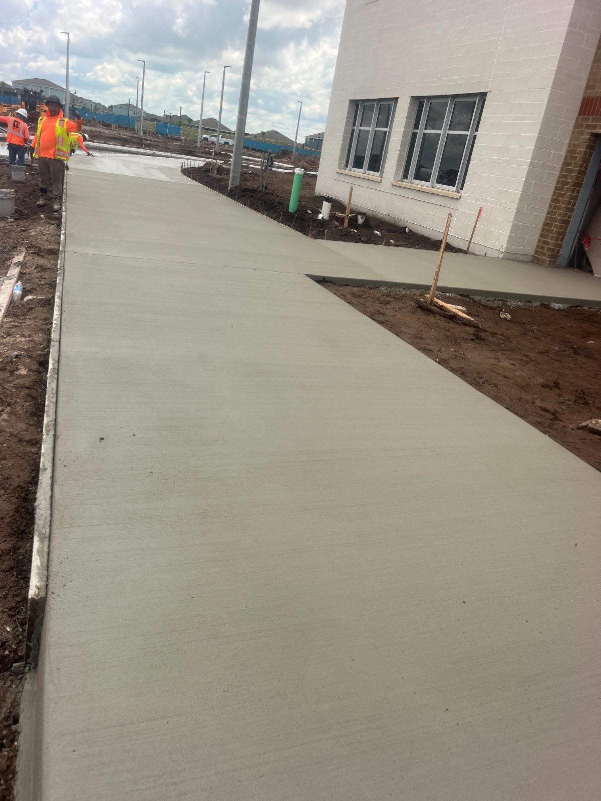 New concrete sidewalk being finished in a residential community